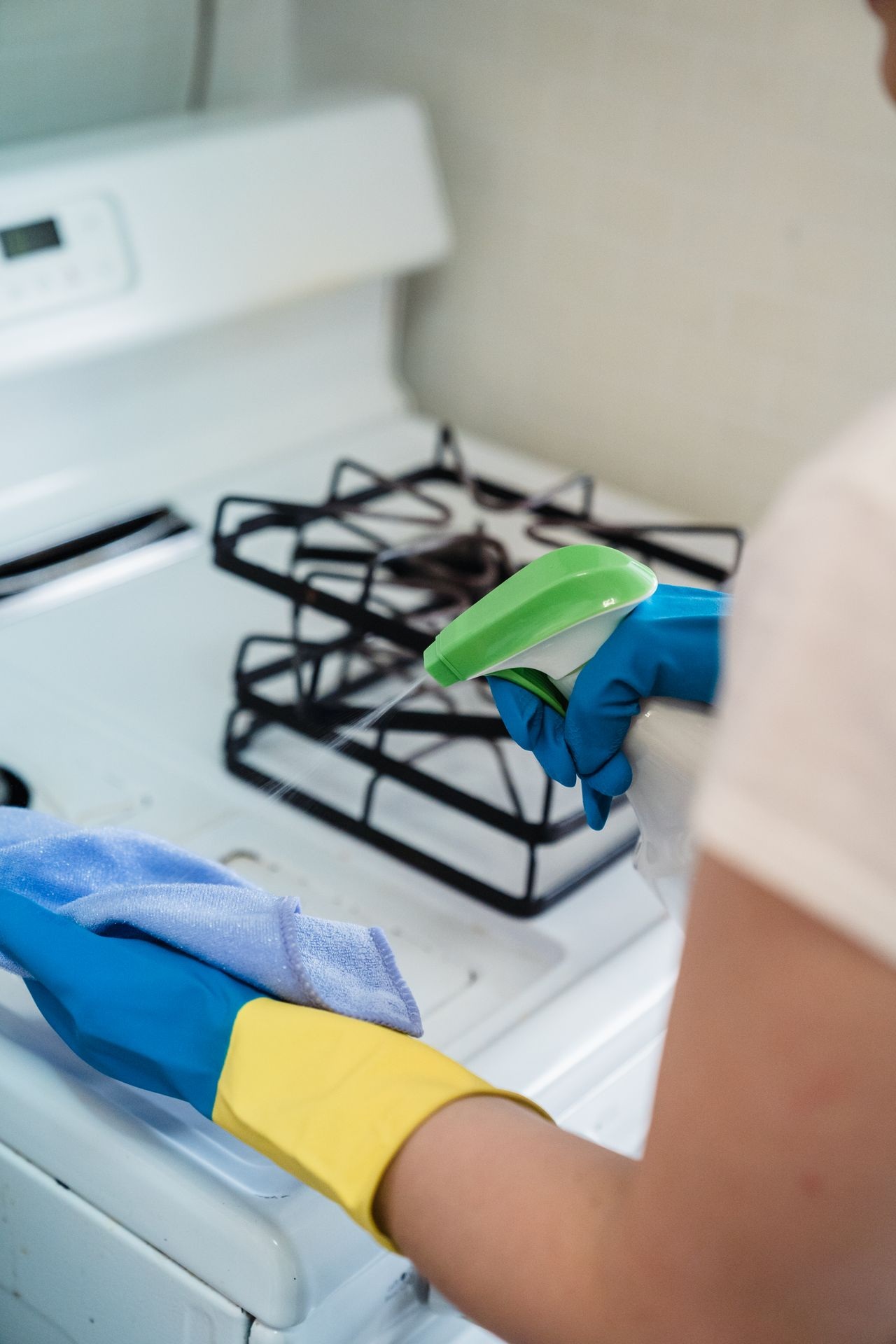 Cleaning prices depend on the job: a cleaner degreasing a kitchen hob