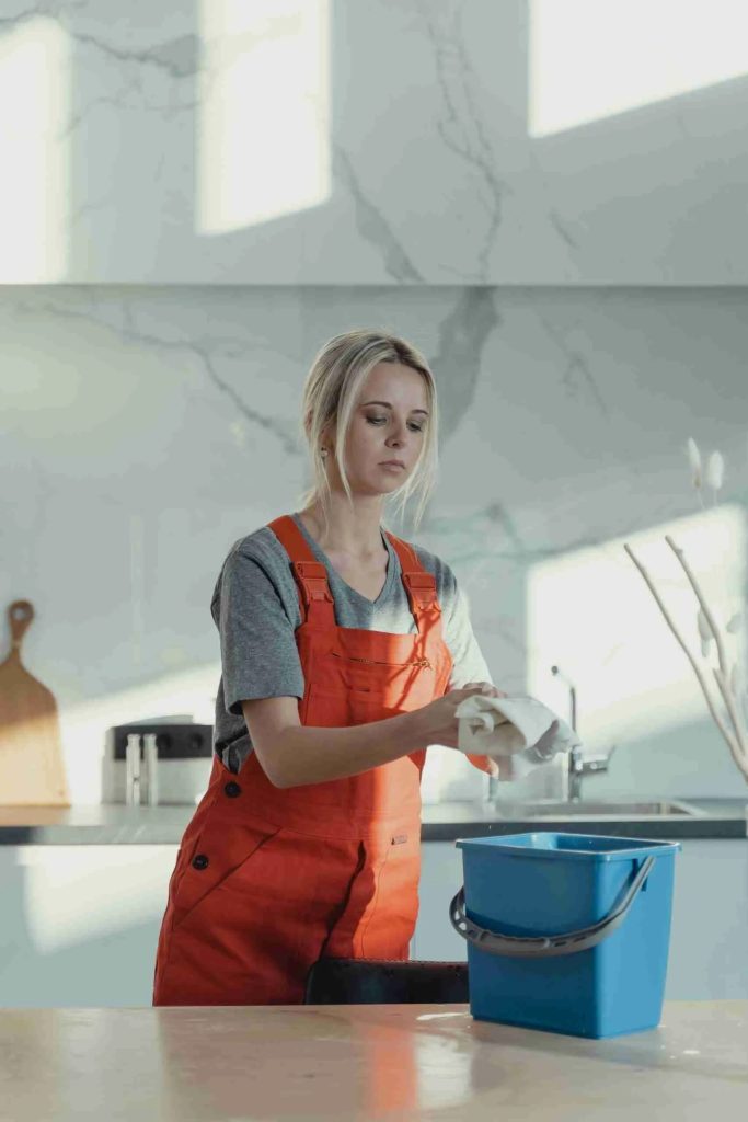 Cleana.uk cleaner wiping a marble worktop during a luxury home clean in West London